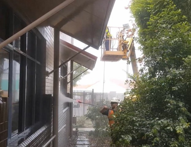 Team working cleaning the exterior of a building
