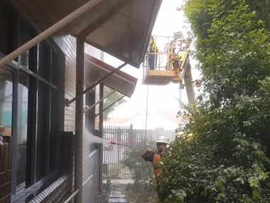 Team working cleaning the exterior of a building
